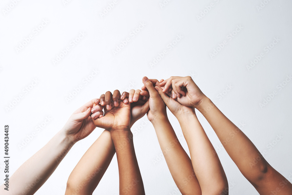 Poster let your hands do the talking. studio shot of a group of unrecognizable people holding each others t