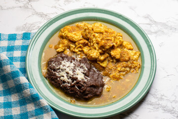 Scrambled eggs with red sauce and beans. Mexican food