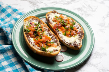 Molletes with fresh sauce and cheese. Mexican food