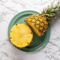 Cutted pineapple fruit on marble background