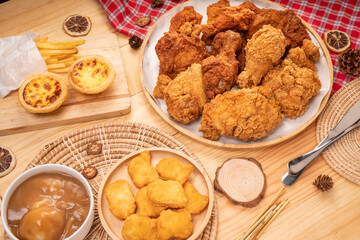 Fried chicken egg tart and french fries in wooden plate on wooden background, Deep fry Chicken and nuggets on wooden table