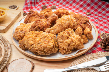 Fried chicken in wooden plate on wooden background, Deep fry Chicken on wooden table.