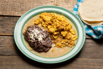 Scrambled eggs with red sauce and beans. Mexican food