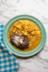 Scrambled eggs with red sauce and beans. Mexican food