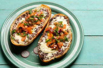 Molletes with fresh sauce and cheese. Mexican food