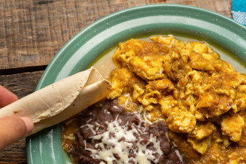 Scrambled eggs with red sauce and beans. Mexican food