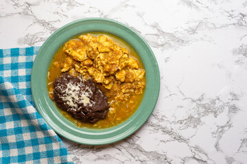 Scrambled eggs with red sauce and beans. Mexican food