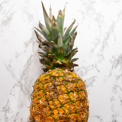 Ripe pineapple fruit on marble background