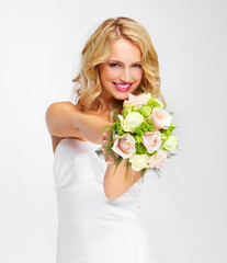 Obraz na płótnie Canvas Its the perfect bouquet. Gorgeous young bride holding out her bouquet towards you - portrait.