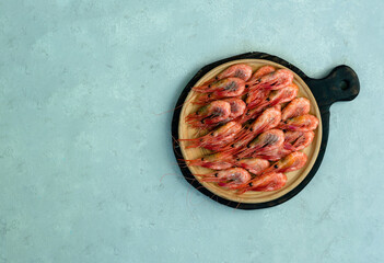 The shrimps are on the white plate. High quality photo