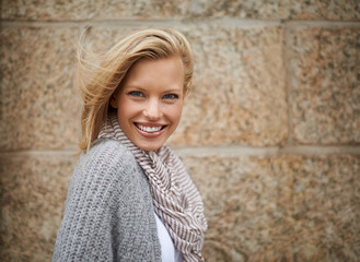 Warm and stylish. Cropped portrait of a pretty young blonde in warm winter fashion.