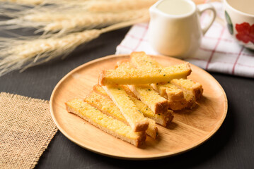 Garlic roasted bread stick on black background, a popular Asian snack food