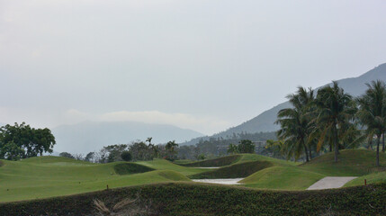 View of the golf course on the background of the mountains