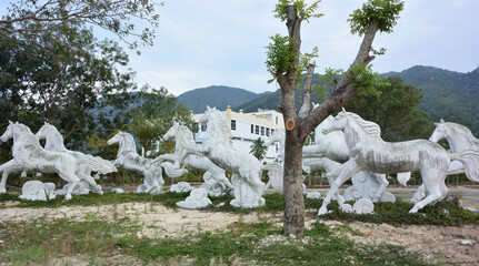 Sculptures of galloping horses against the background of mountains