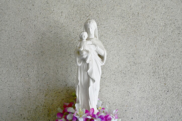 Statue of Our lady virgin Mary with Child Jesus located in the catholic church with natural background, Thailand. selective focus.