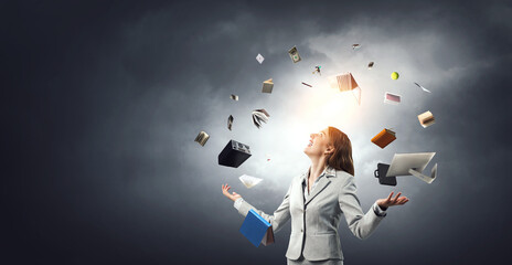 Young pretty businesswoman juggling with business items