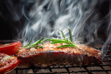 Steak on the grill with flames With Rosemary Pepper And Salt - Barbecue.selective focus