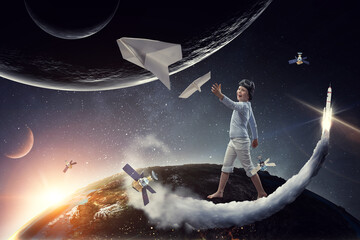 Obraz na płótnie Canvas Happy kid playing with paper airplane
