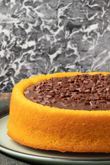 Carrot cake covered with granulated chocolate .