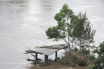 Partially submerged Buildingins in Receding Flooded Brisbane River at Colleges Crossing Recreation...