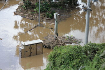 Partially Submerged Small Power Station in Floodwaters Colleges Crossing, Brisbane River, near...