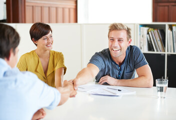 I think this will work for everyone. Shot of a young couple meeting with their financial advisor.