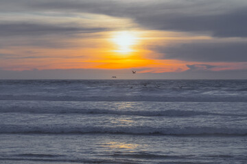 Sunset over the Pacific Ocean, beautiful seascape in light blue and yellow colors