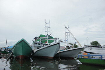 Fototapeta premium fishing boats dock at the harbor to sail for fish as a supplier of fresh fish