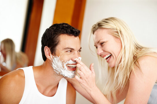 Best Friends Make The Best Relationships. Shot Of A Young Woman Putting Shaving Cream On Her Husband And Laughing.