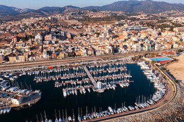 View from drone of town El Masnou and many boats in bay, province of Barcelona, Catalonia, Spain