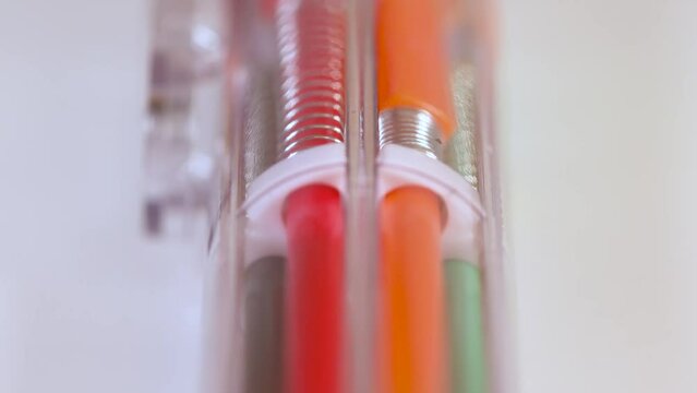 Close up view with linear motion of Multi color ball point pen 