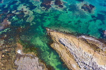 Naklejka na ściany i meble Aerial views of rocky coastal reef popular for swimming in Australia