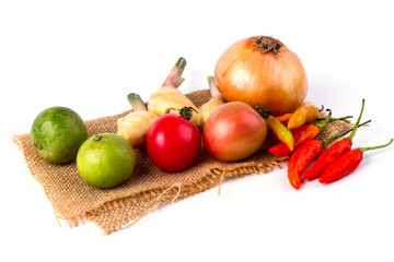 Mixed fruits and vegetables are placed on the sack. on white background
