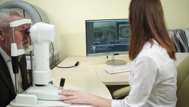 ophthalmologist examination of elderly man on corneo topographer.modern clinic