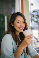 a pretty woman drinking coffee 