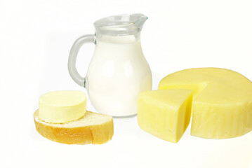 Milk in a jug, butter on a slice of bread, cheese on a plate. Gradient yellow background. 