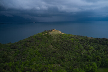 Fototapeta na wymiar Aerial view of Punta Sasso at Lake Garda, Italy. Rain clouds over the Alps Lake Garda.