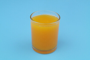 Fresh orange juice on blue background	