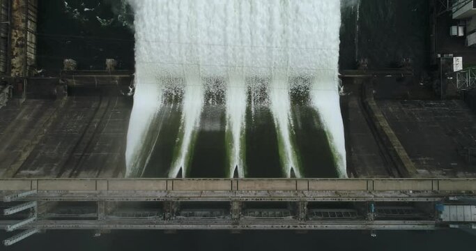 Hydroelectric dam top view. Discharge of water at hydroelectric power plants. Big waterfall. Electricity. Krasnoyarsk hydroelectric power station. Yenisei river.