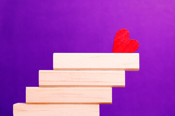 Red heart on top of wooden steps

