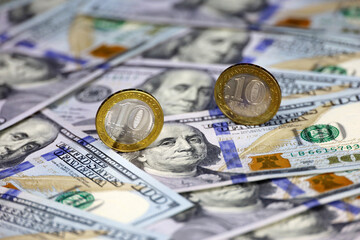 Russian rubles coins on background of US dollars. Concept of exchange rate, american sanctions...