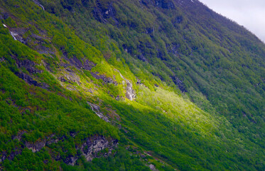 Breathtaking scenery of mountains, galciers and waterfalls in Geirangerfjord during cruising to...