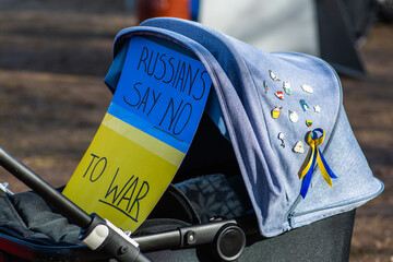 Stroller with placard during a peaceful demonstration against war, Putin and Russia in support of...