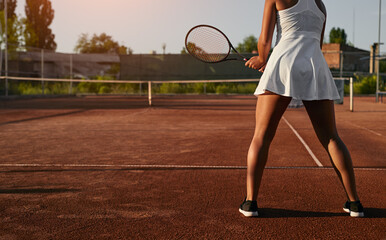 Unrecognizable female tennis player training on court
