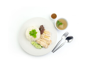 Top view of Hainanese chicken rice with hot soup and spicy sauce isolated on white background