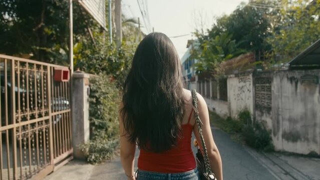 beautiful trans woman walking down the street then turns around and looks at the camera