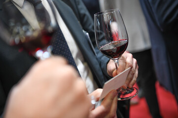 People tasting red wine at professional exhibition, High quality photo