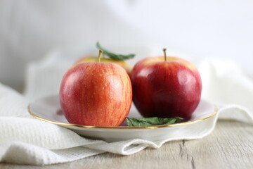 three ripe sweet apples on a table