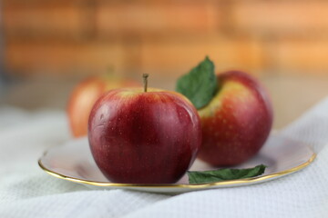 three ripe sweet apples on a table