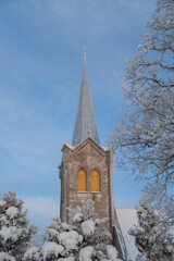 The steeple of the Church of the Blessed Virgin Mary in Joelahtme (Estonian - Püha Neitsi Maarja kirik, Jõelähtme) on a sunny winter morning. One of the oldest churches in Estonia. 